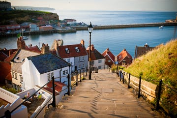 rooftops of whitby abbey by sea and steps