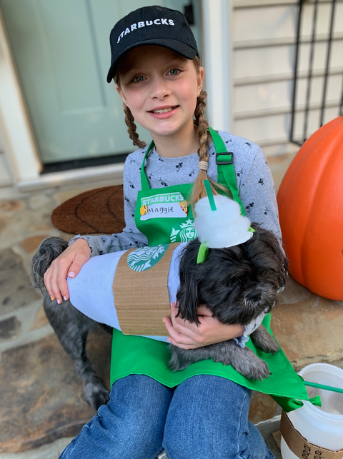 girl dressed as starbucks employee and dog dressed as puppuccino