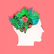 Plants and flowers with head made of paper on red background think green, paper craft head made with paper with plants and flowers growing in there on red background