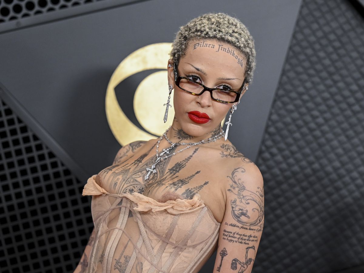Doja Cat suffers a nip slip in VERY racy sheer corset dress and shows off  multiple temporary tattoos - including FOREHEAD ink - at Grammys 2024