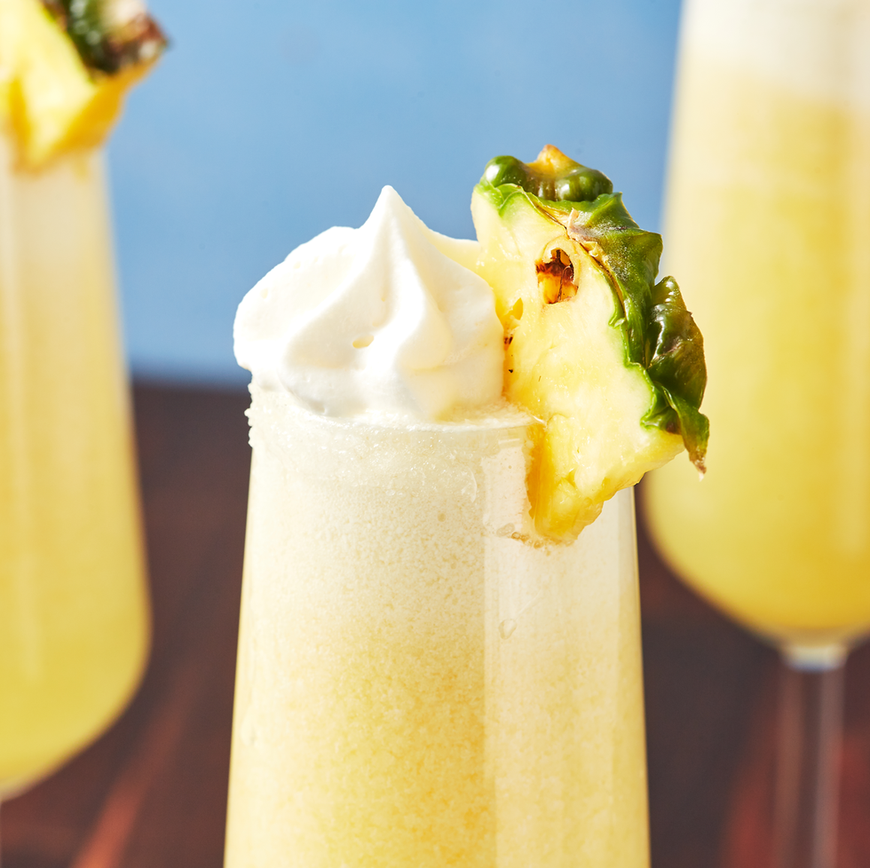 mimosas with pineapple and whipped cream on top