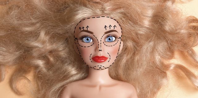 Doll with face marked up for plastic surgery