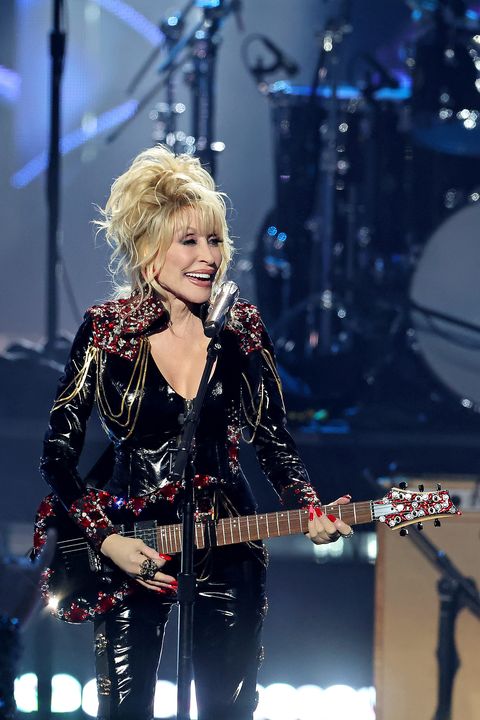 dolly parton performing in all leather at 37th annual rock  roll hall of fame induction ceremony