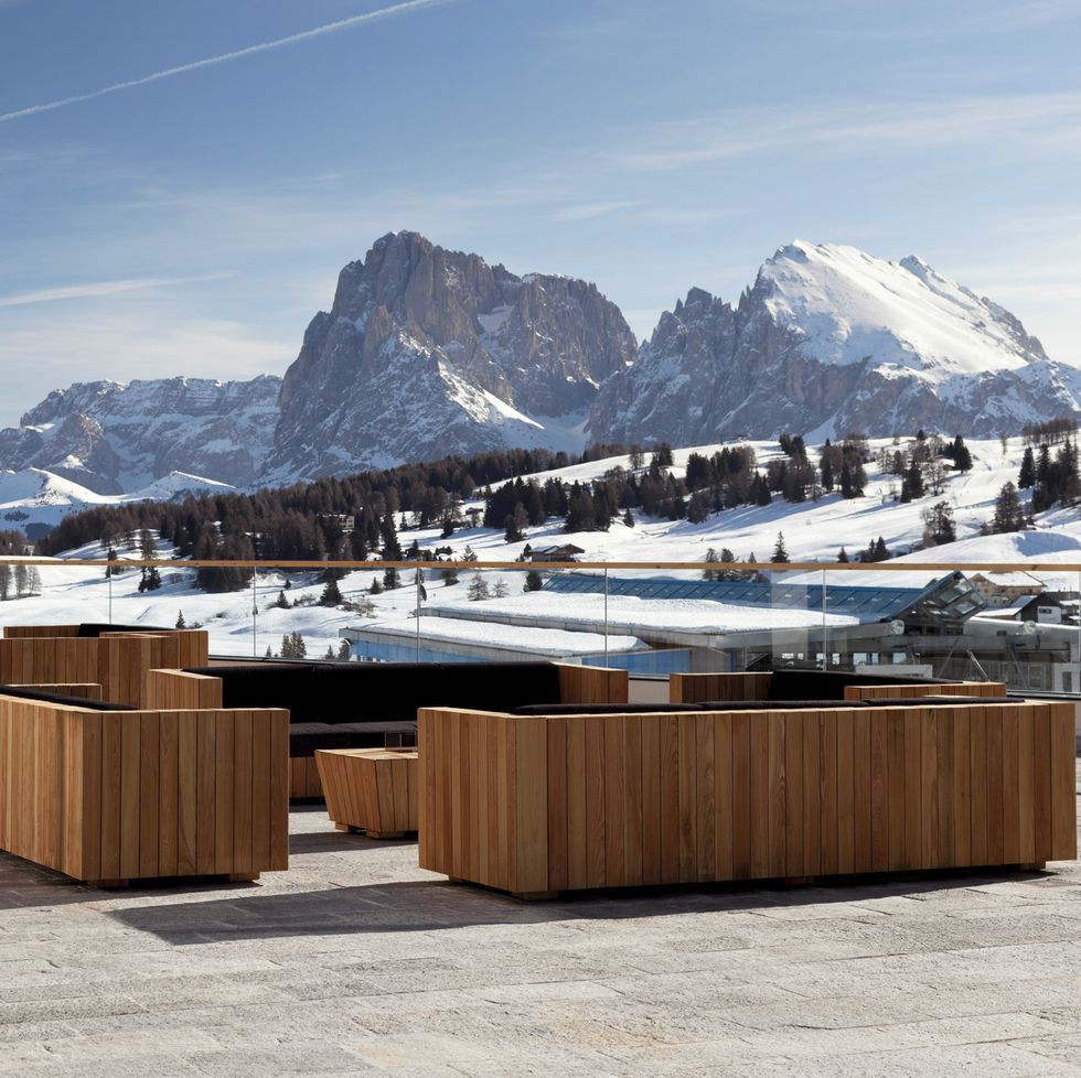 a snowy mountain range behind a wooden fence, como alpina dolomites, south tyrol, italy