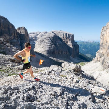 runner navigating a rocky mountain trail in a scenic landscape runner navigating a rocky mountain trail in a scenic landscape