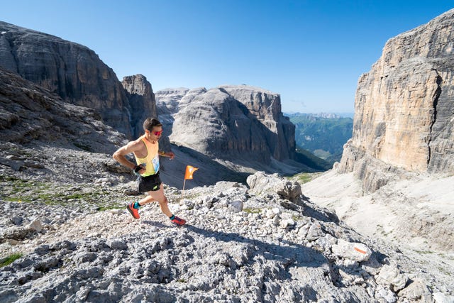runner navigating a rocky mountain trail in a scenic landscape