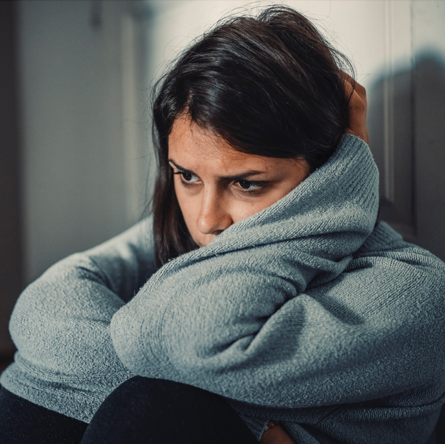 woman in distress sat by front door