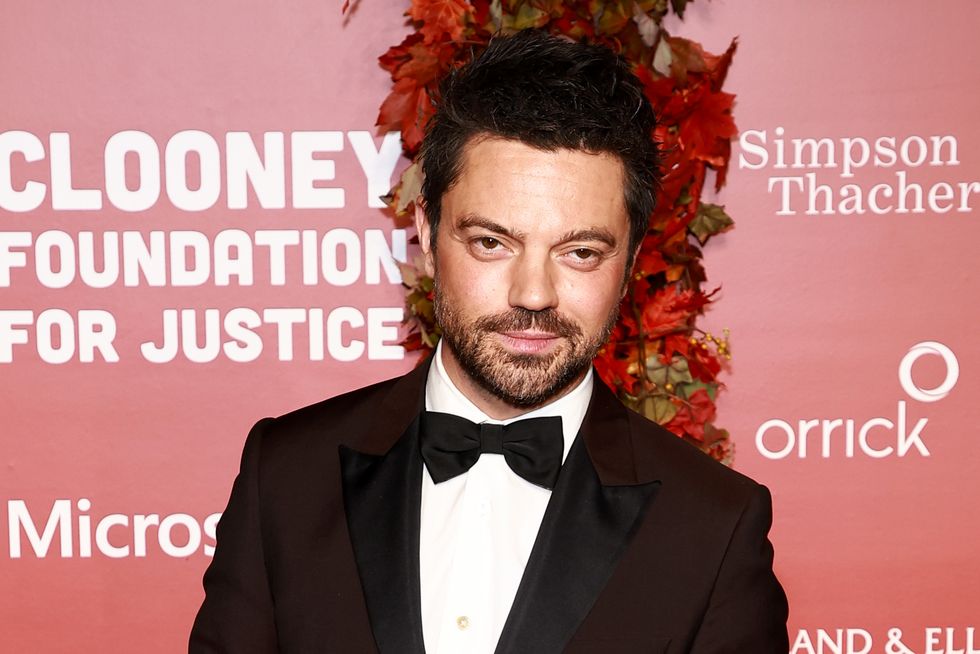 dominic cooper wears a black tuxedo and smiles for the camera