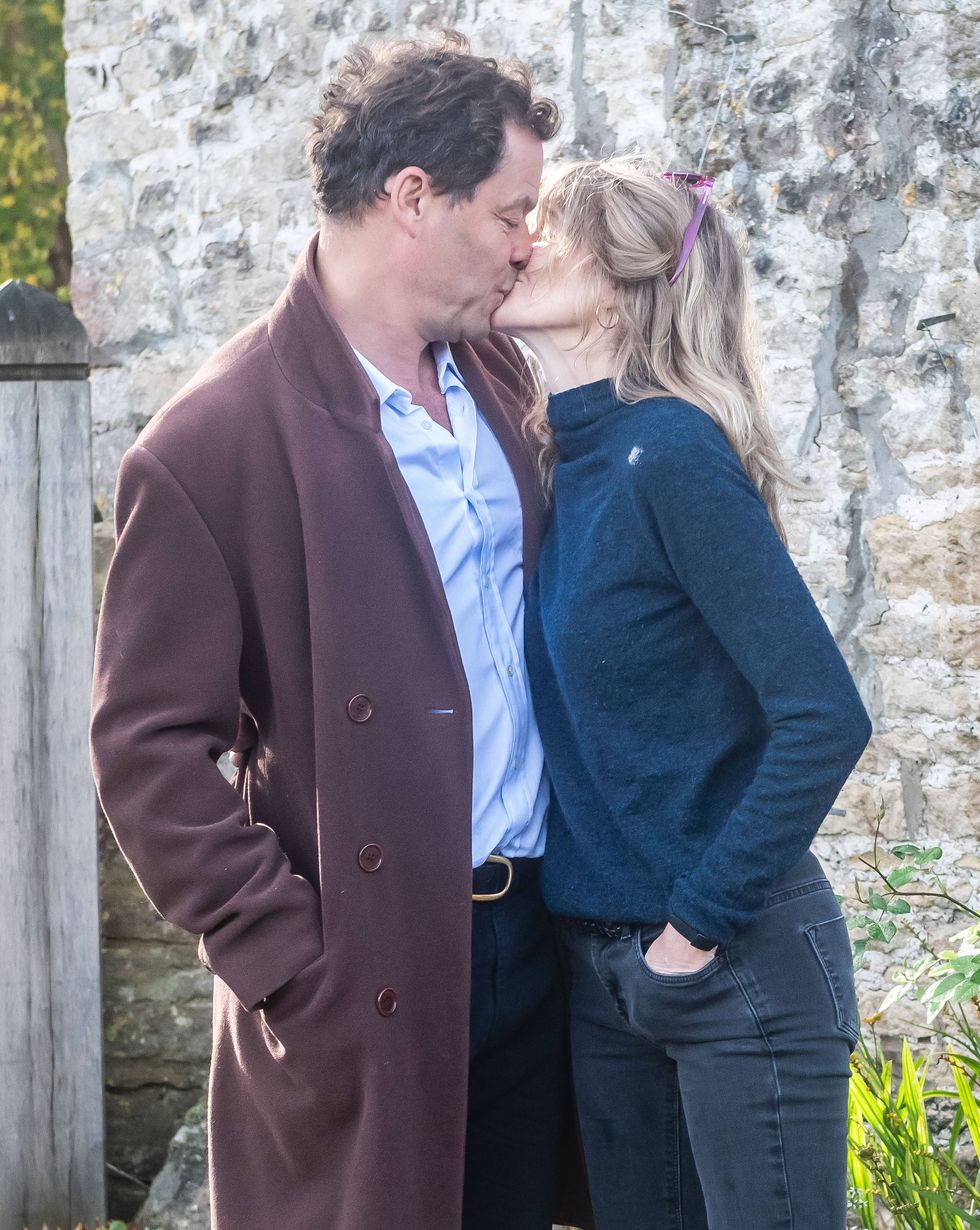 dominic and his wife kissing outside their cotswolds home on october 2020