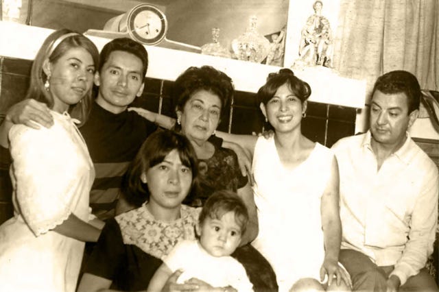 dona natalia and some of her fictive kin, back row, left to right, eloisa wongpec, salvador “chavo” barrajas, natalia barraza, irene wongpec, carlos porras, front row, lilia wongpec holding maría’s son david on her lap