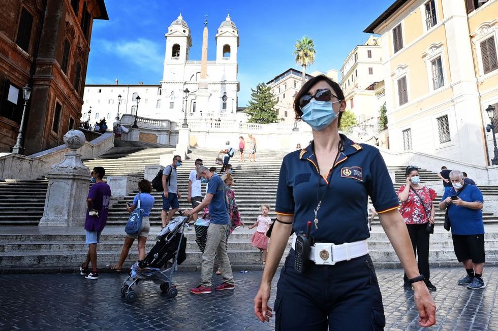 italian local police officer patrols and checks with people wear protective facemasks at the spanish steps square, in rome on august 17, 2020 as italy declared mandatory to wear a protective facemask in all places where assemblies can be created to fight against the spread of the covid 19 novel coronavirus photo by alberto pizzoli  afp photo by alberto pizzoliafp via getty images