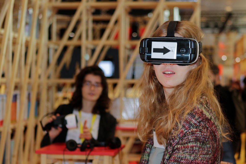 A visitor uses an Oculus Rift VR headset at the French