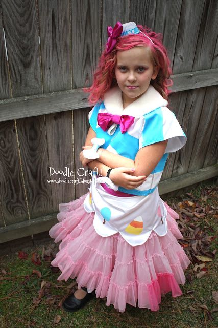 little girl dressed as pinkie pie from my little pony going to the gala in pink tulle skirt, striped blue and white shirt with a pink bow, pink hair with a blue and white cap with a pink bow