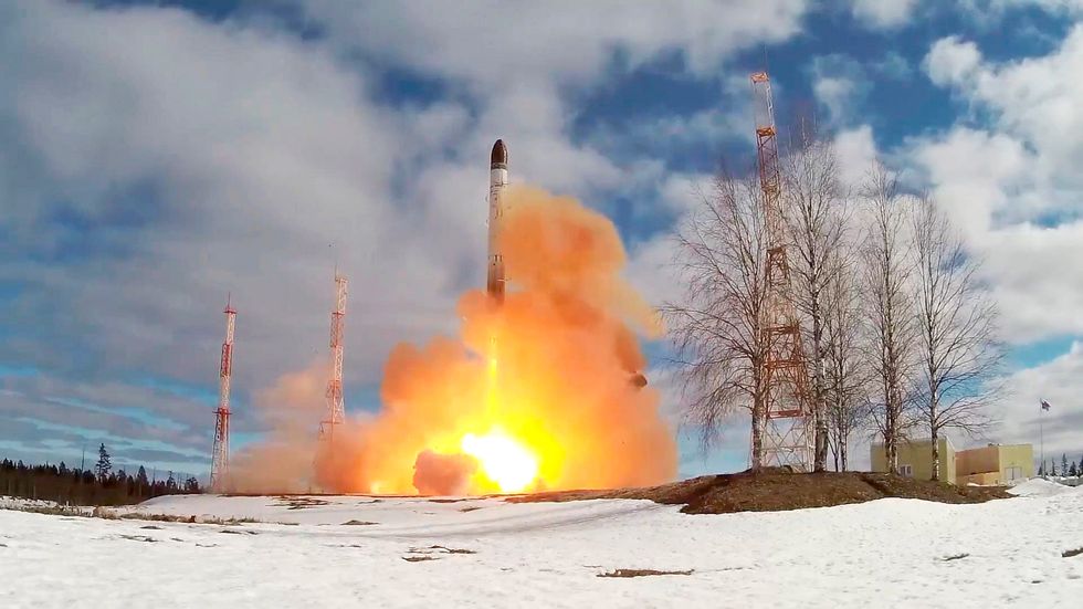 a rocket launching with a fire in the background