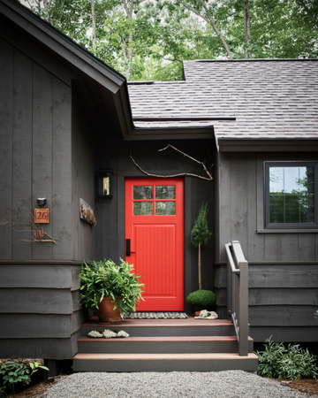 the orange painted front door of the lodge