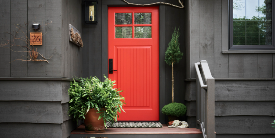 the orange painted front door of the lodge