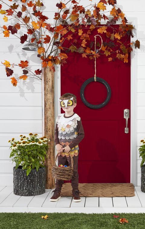 crafted tree door surround made from a mailing tube and branches of fall leaves