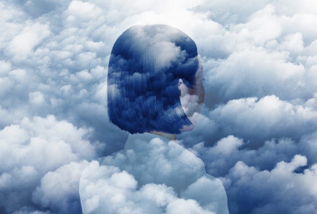 double exposure of woman looking off into sky and clouds