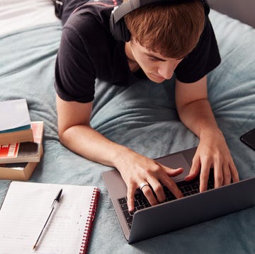 working on laptop in bed