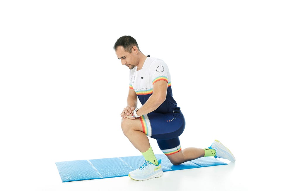 a man in a uniform squatting