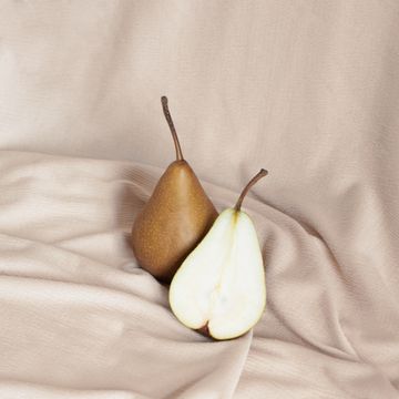 a couple of pears on a bed