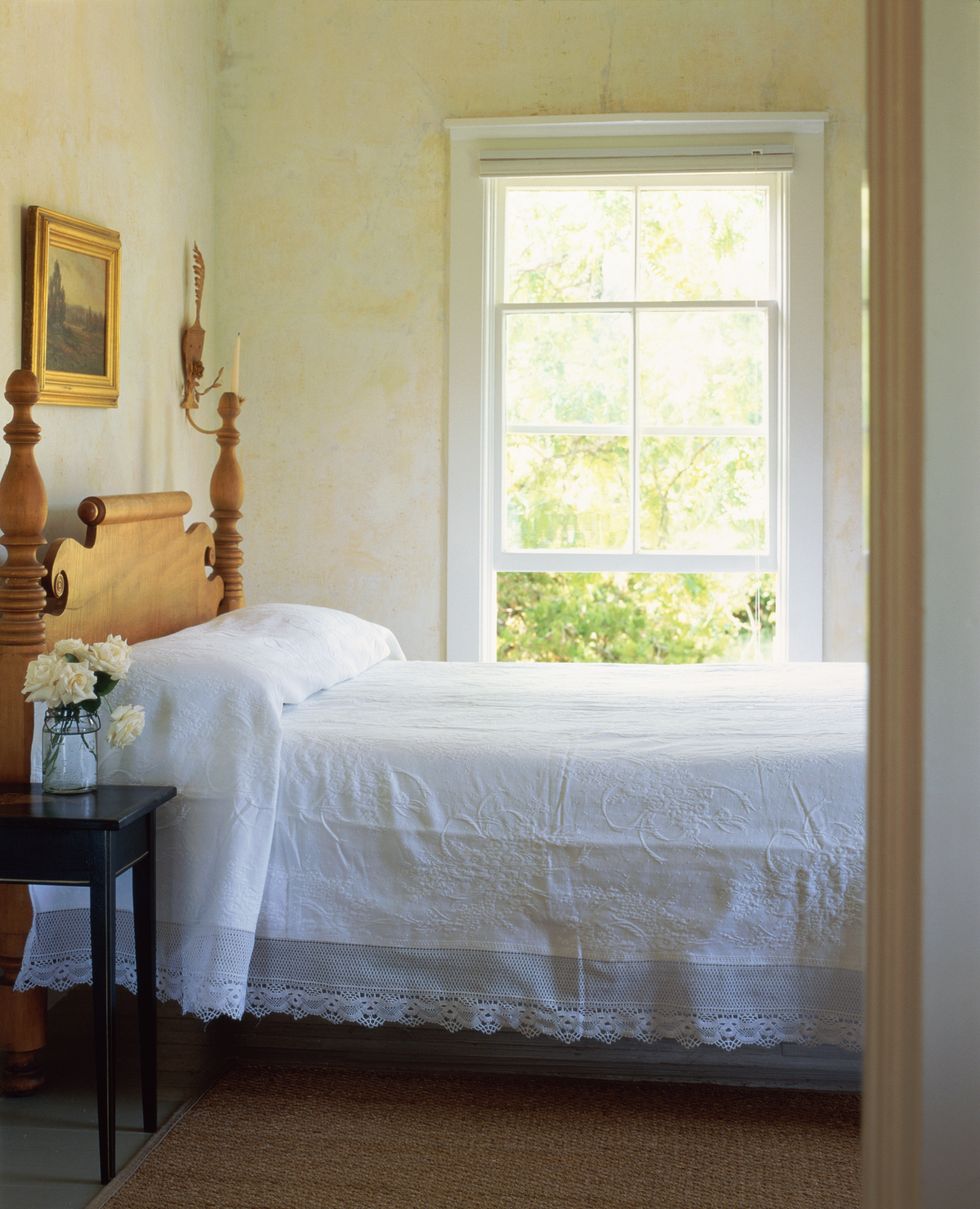 double bed in bedroom, window open, view through doorway