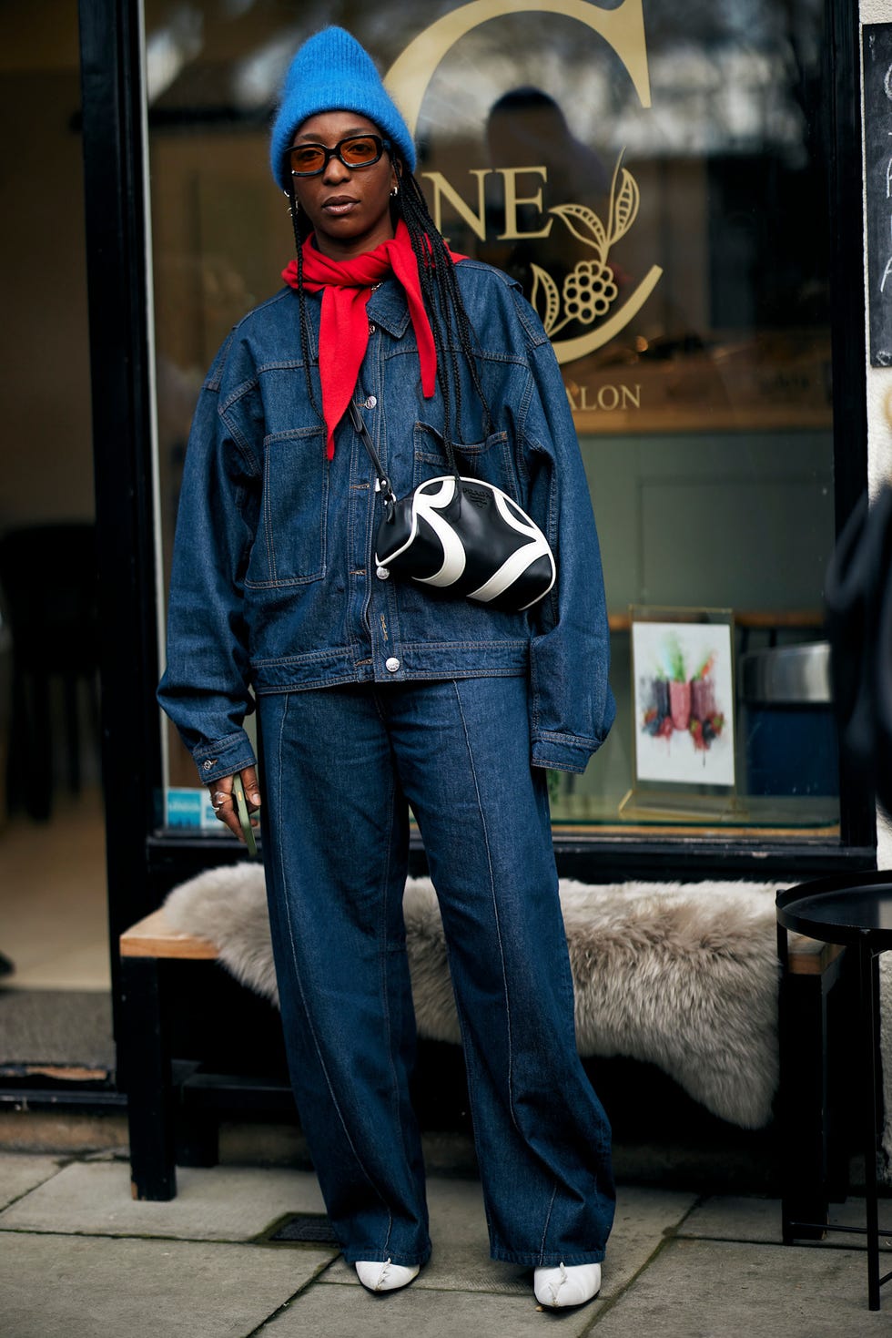 fashionable person wearing double denim with colour pop accessories