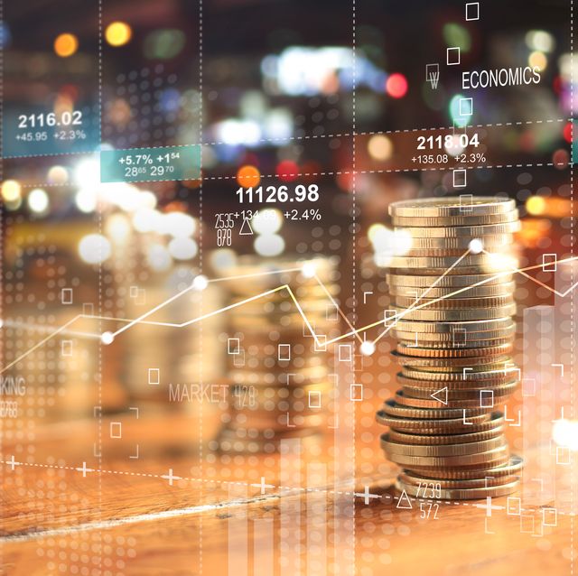 double explosure with businesss charts of graph and rows of coins for finance at night city background