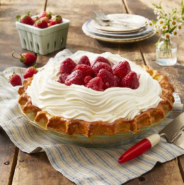 a pie with whipped cream and strawberries on top