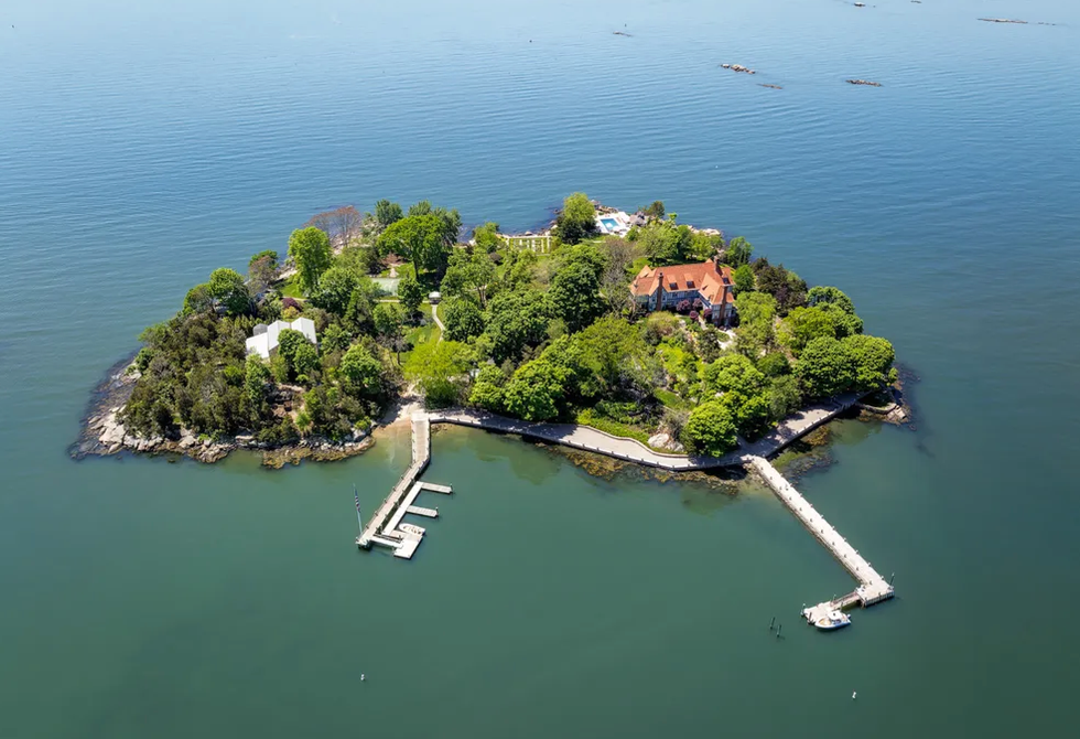 an island with trees and a house