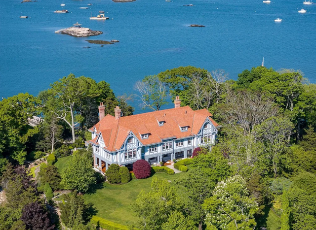 a house surrounded by trees and water