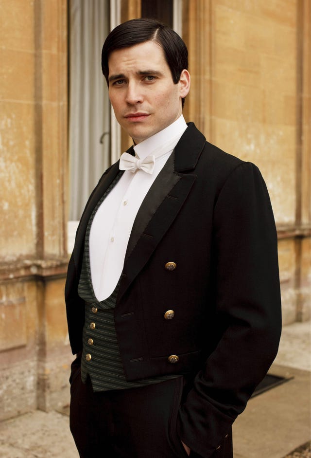 a person wearing formal attire standing outside a building