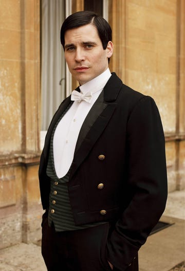 a person wearing formal attire standing outside a building