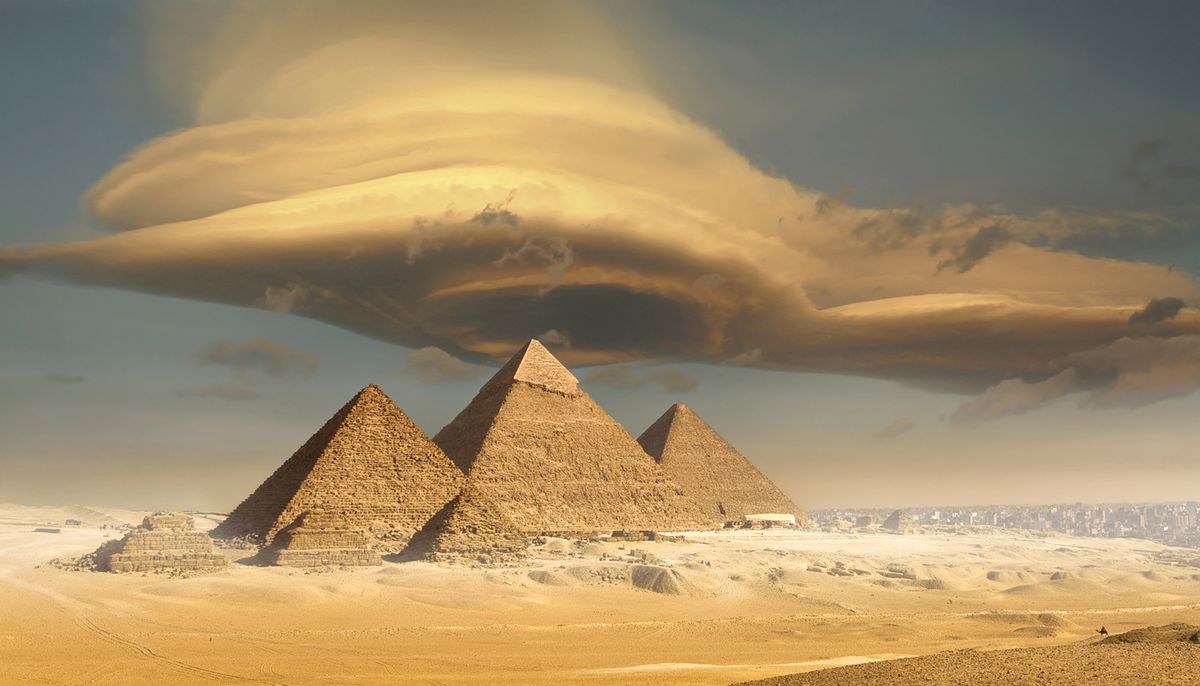 dramatic storm cloud above pyramids, giza, egypt
