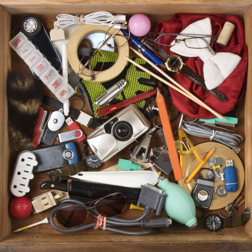 drawer full of junk, of various household items on a white background with clipping path