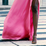 woman wearing a dress and crossing the crosswalk