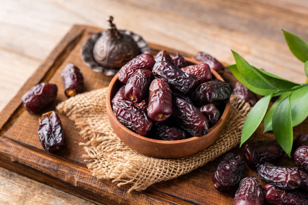 dried date fruits in wooden bowl