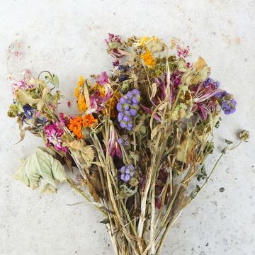 germany, bavaria, a bunch of withered field flowers and pink roses on a grey slab
