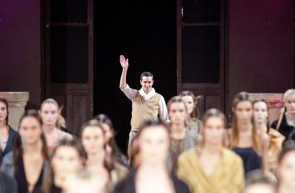 a man waving behind a group of women