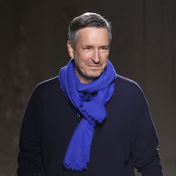 dries van noten walking at the aw24 show with a blue scarf on