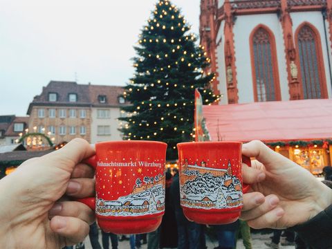 drinking gluhwein mulled wine at christmas market in germany
