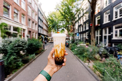 drinking iced cold bubble tea with tapioca pearls on the street, personal perspective view