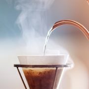 drip coffee, barista pouring water on coffee ground with filter