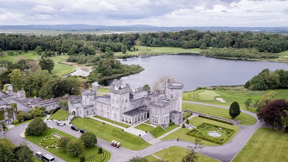 historic castle surrounded by lush landscapes and a lake