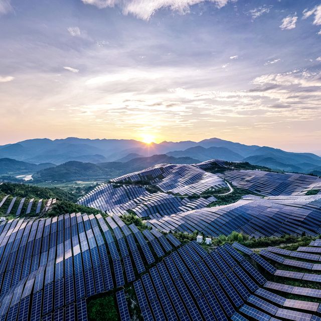 drone point of view at the solar power station on the top of the mountain at sunset