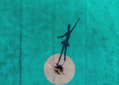 drone view of creative picture of ballerina stands out from circle with color