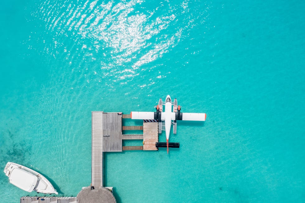 drone view of seaplane docked at hotel pier