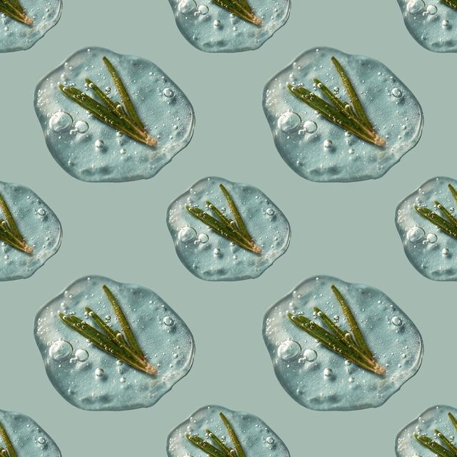 a drop of cosmetics gel with rosemary on a green background
