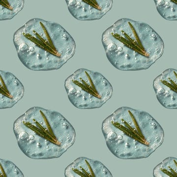 a drop of cosmetics gel with rosemary on a green background