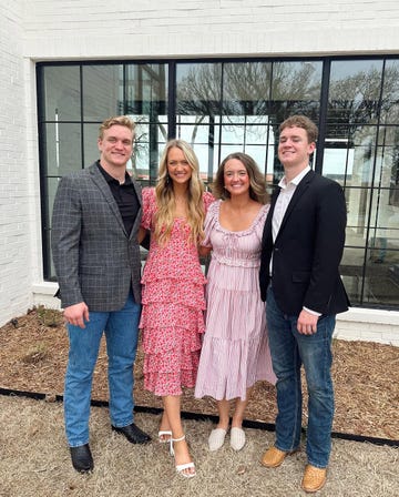 four individuals posing together outdoors